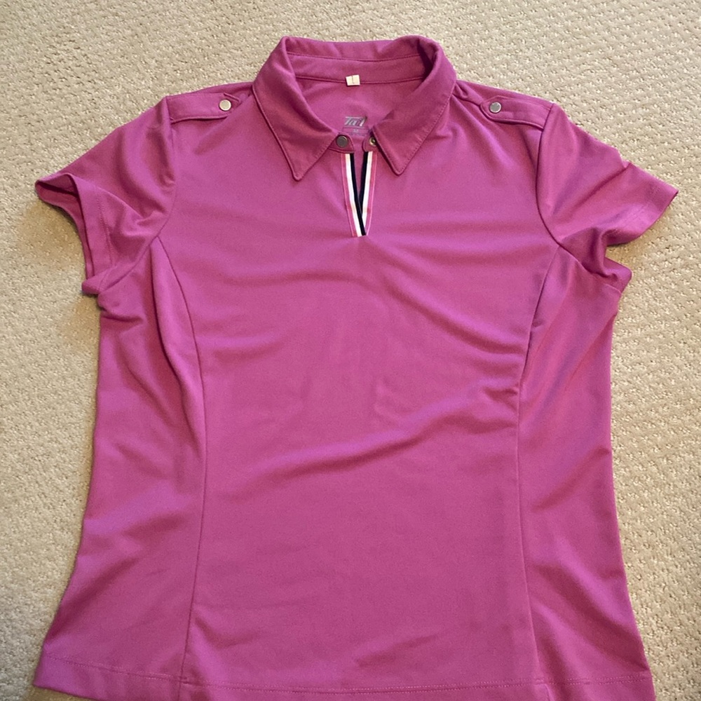 Woman’s Tail golf shirt.  Optional snap on the top by the collar.  Color purple